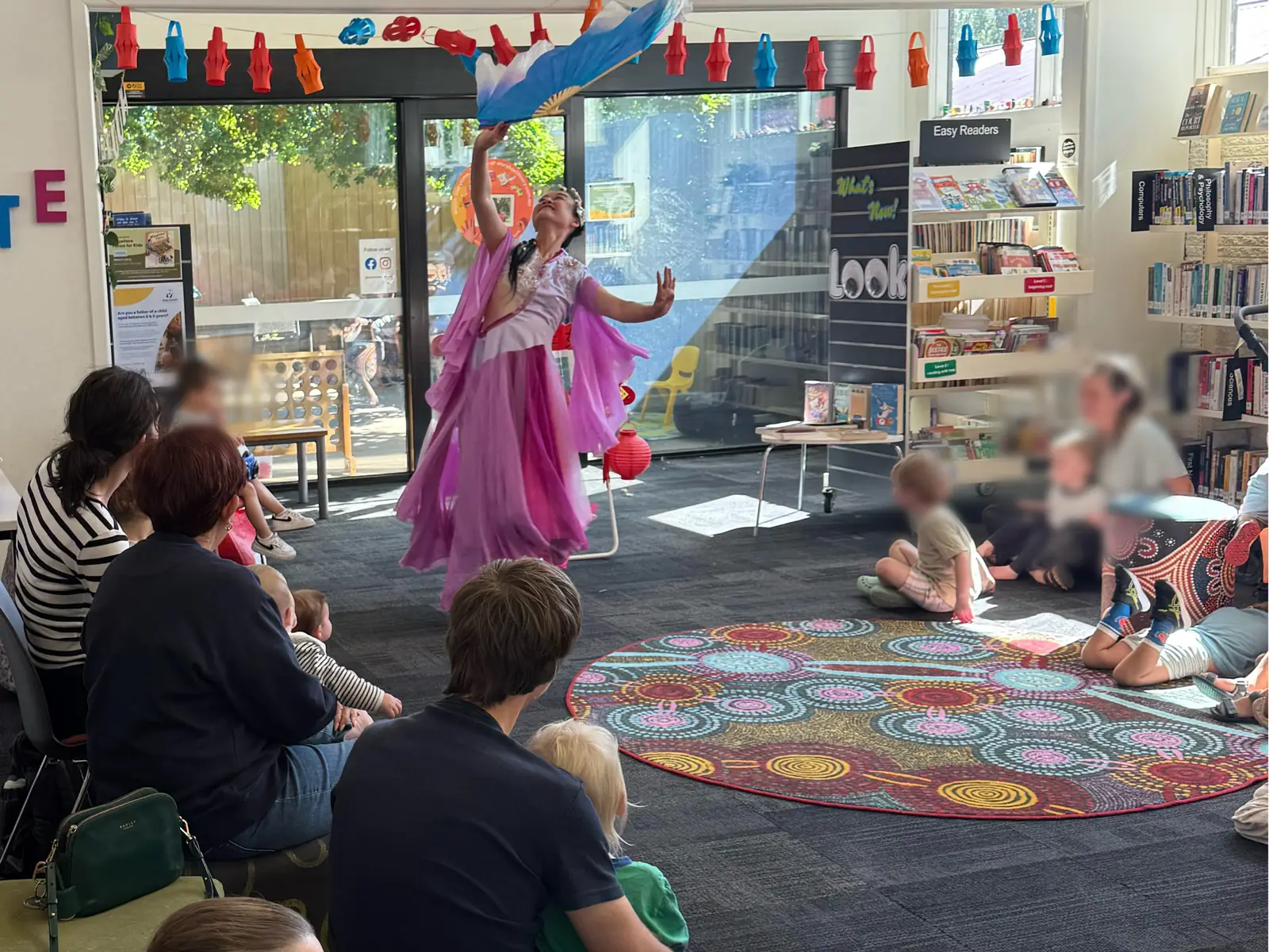 Raina dancing for children and families at a library