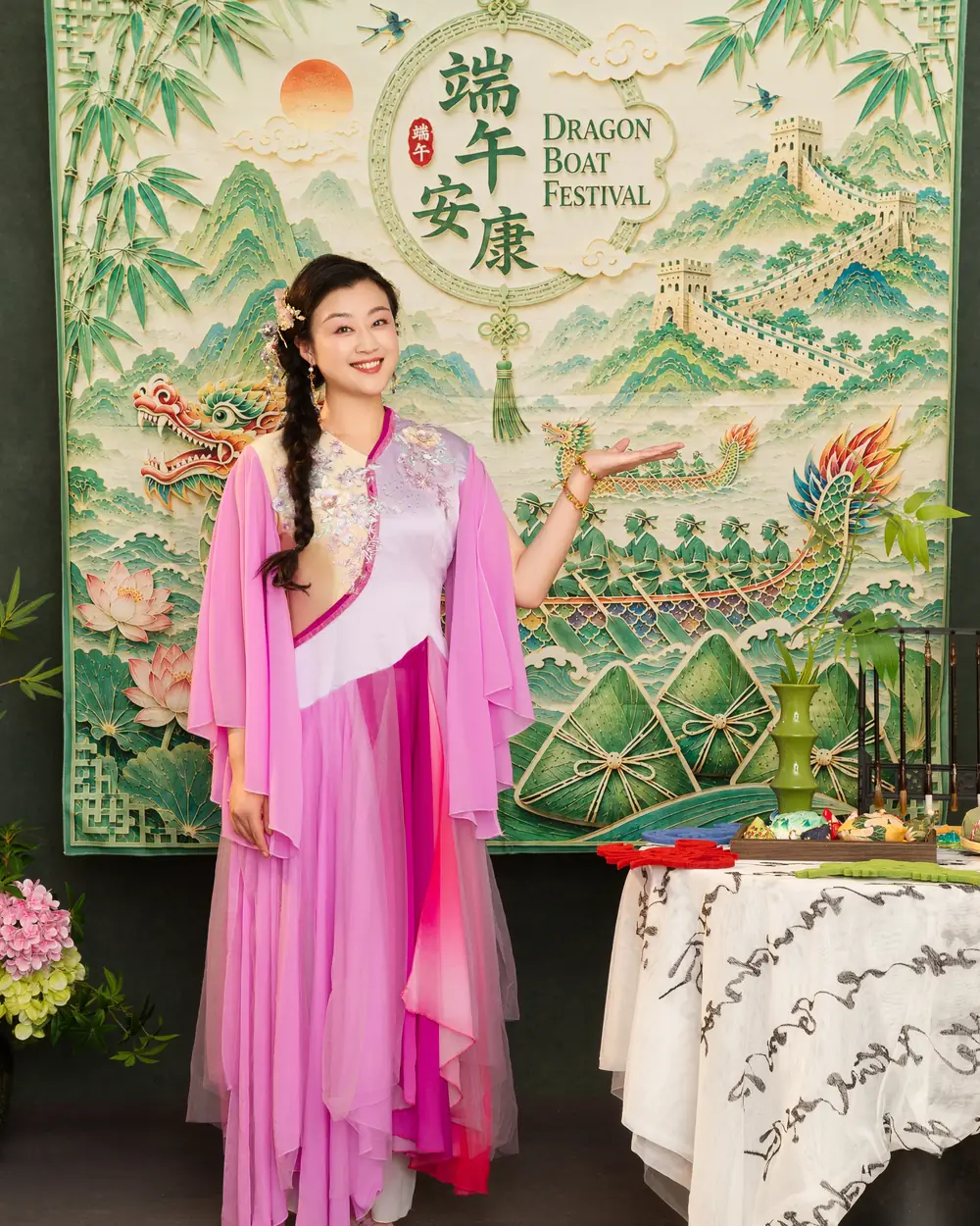 Raina beside a table of Dragon Boat Festival props