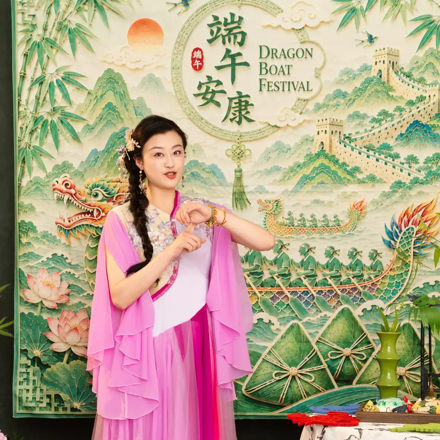 Raina in front of a Dragon Boat Festival backdrop