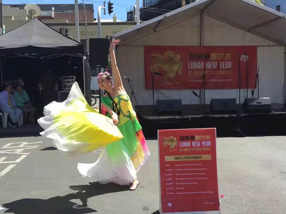 Raina dancing with fans at an outdoor Lunar New Year festival