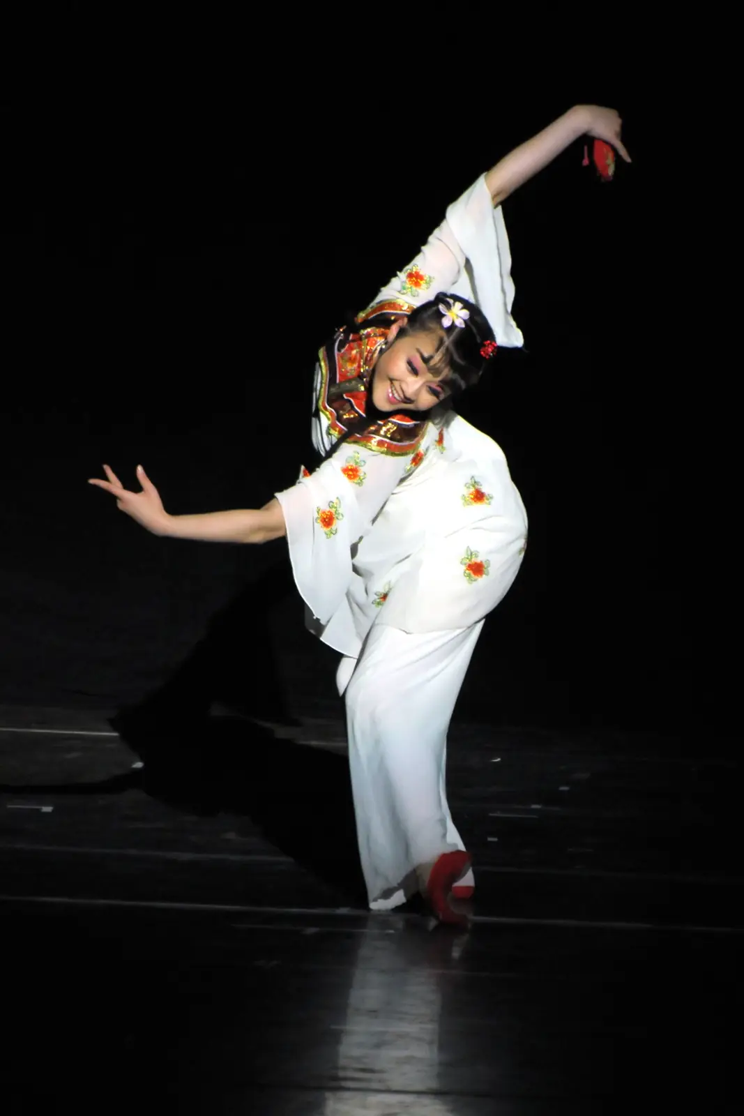 Raina performing a Chinese dance on stage