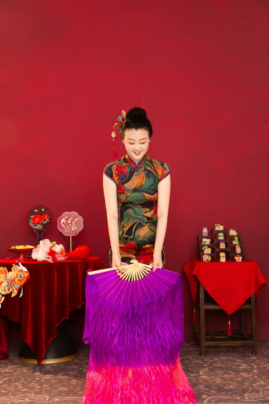 Raina holding a purple silk fan